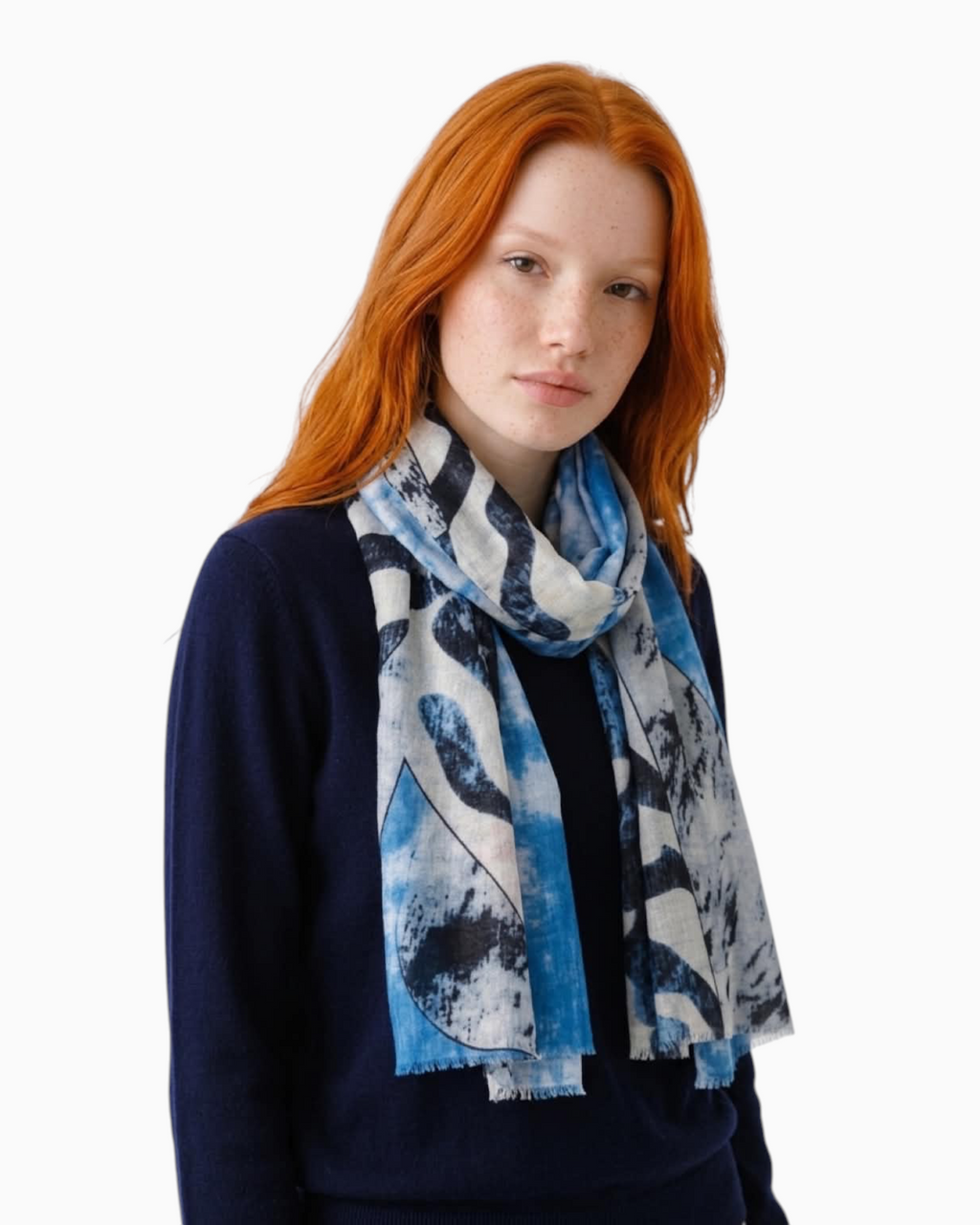 Thrift N Gift lightweight scarf with abstract blue, white, and charcoal print and frayed edges worn by a redhead model