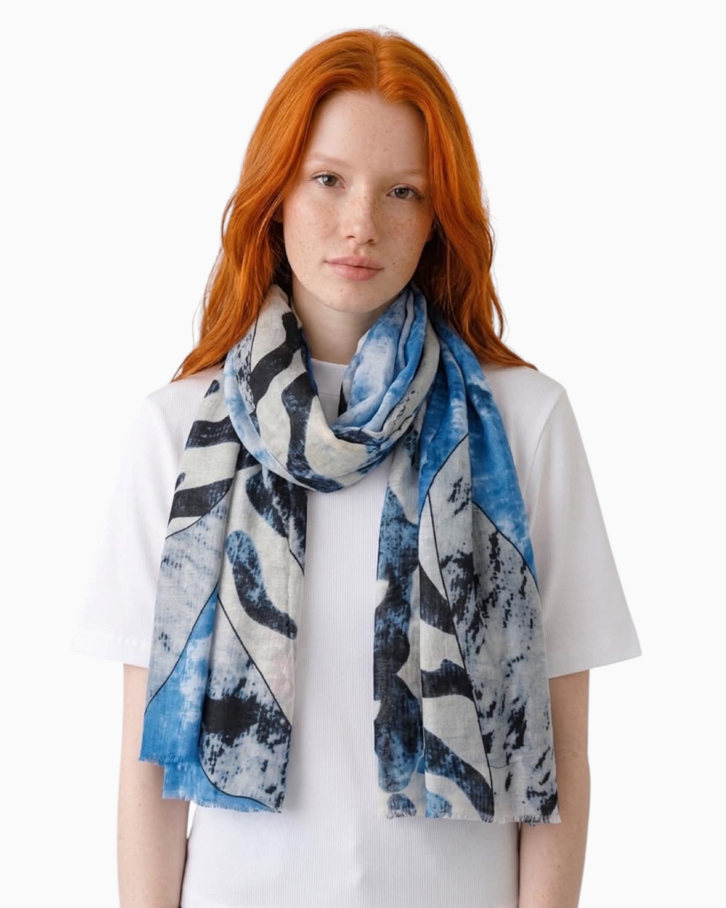 Thrift N Gift lightweight scarf with abstract blue, white, and charcoal print and frayed edges worn by a model.