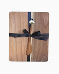 Thrift N Gift acacia wood cheeseboard with a matching wooden bee-themed spreader tied with a black ribbon