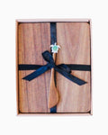 Thrift N Gift acacia wood cheeseboard set with a decorative turtle spreader, tied with a black ribbon in a gift box.