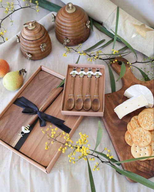 Thrift N Gift set of four acacia wooden spoons with decorative bee motifs in a gift box on a rustic table setting