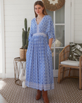 Thrift N Gift model wearing a blue and white geometric print bohemian maxi dress with lace trim and wide sleeves