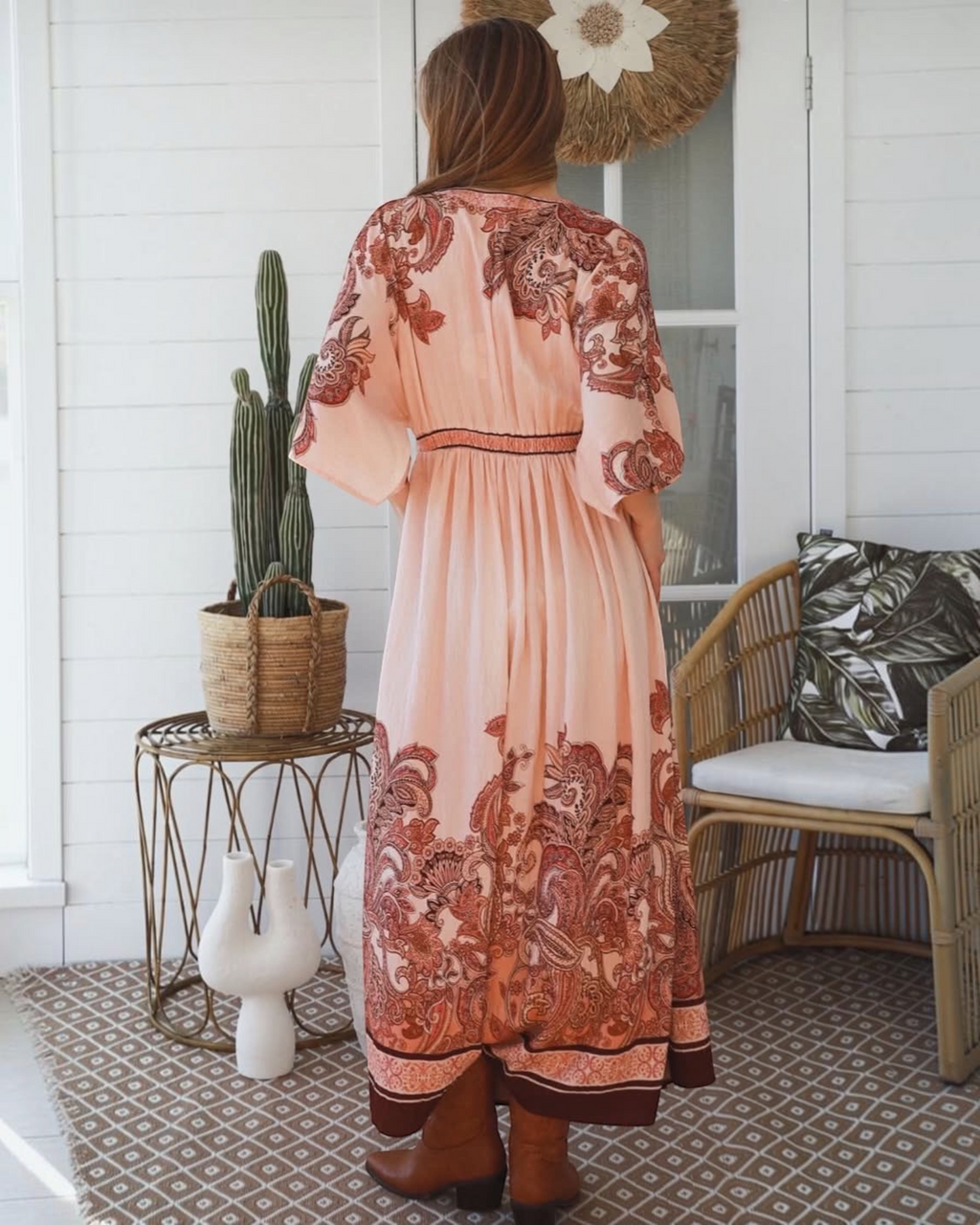 Thrift N Gift bohemian maxi dress in blush pink with terracotta paisley print, kimono sleeves, and brown ankle boots.