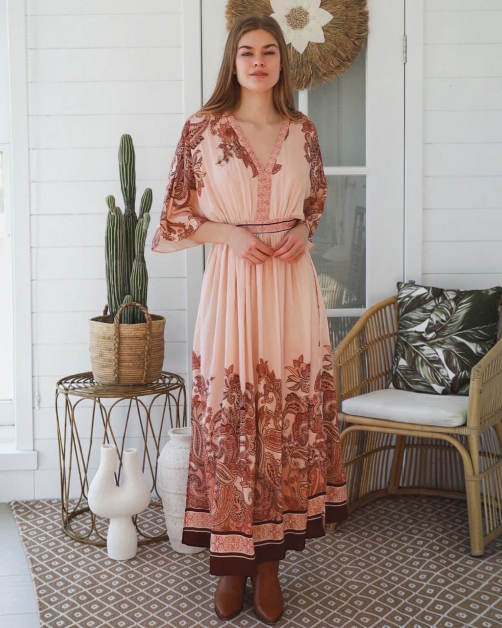 Thrift N Gift bohemian maxi dress in blush pink with terracotta paisley print, V-neck, and kimono sleeves on a model.