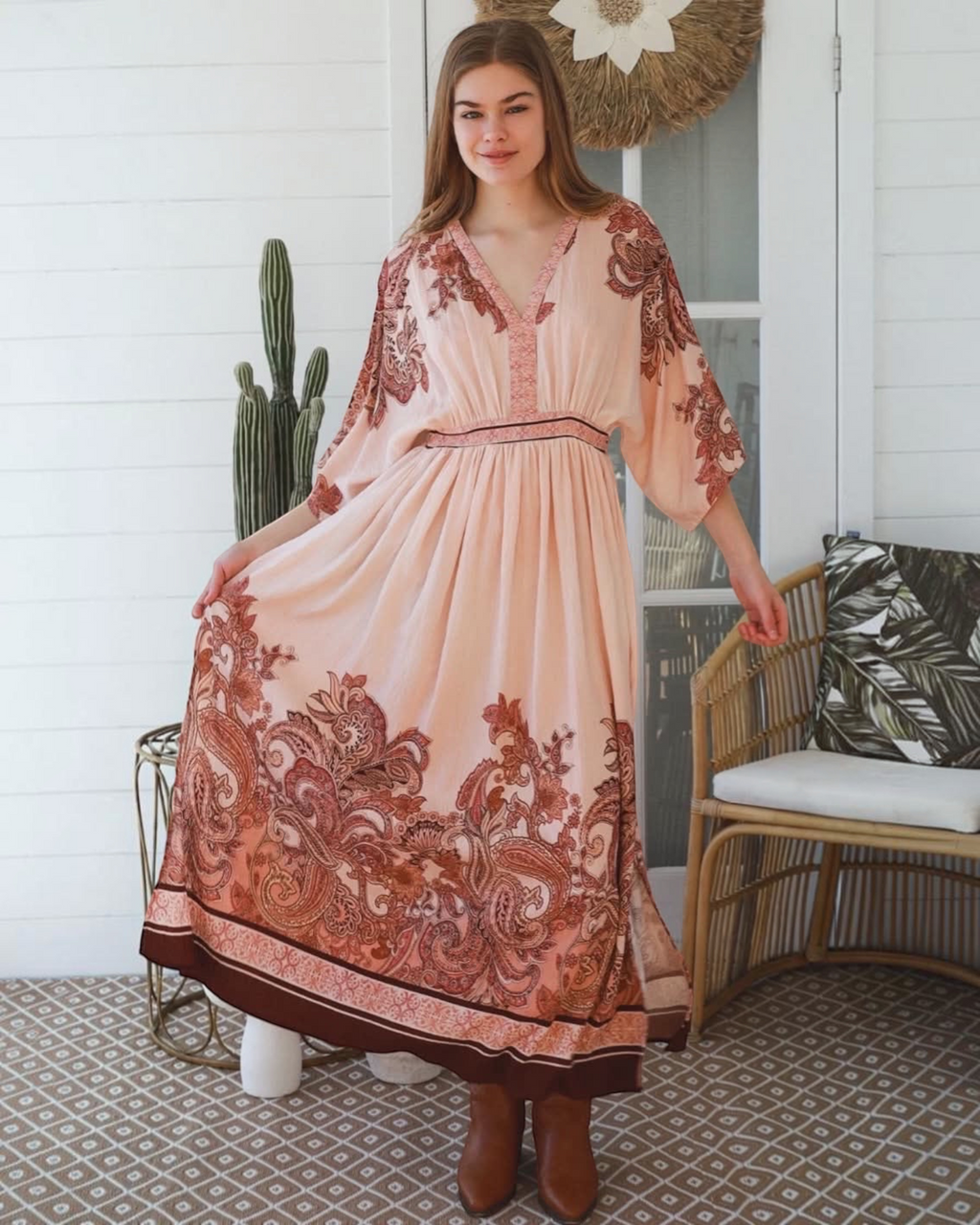Thrift N Gift bohemian maxi dress in blush with terracotta paisley print, V-neck, and kimono sleeves on a model.