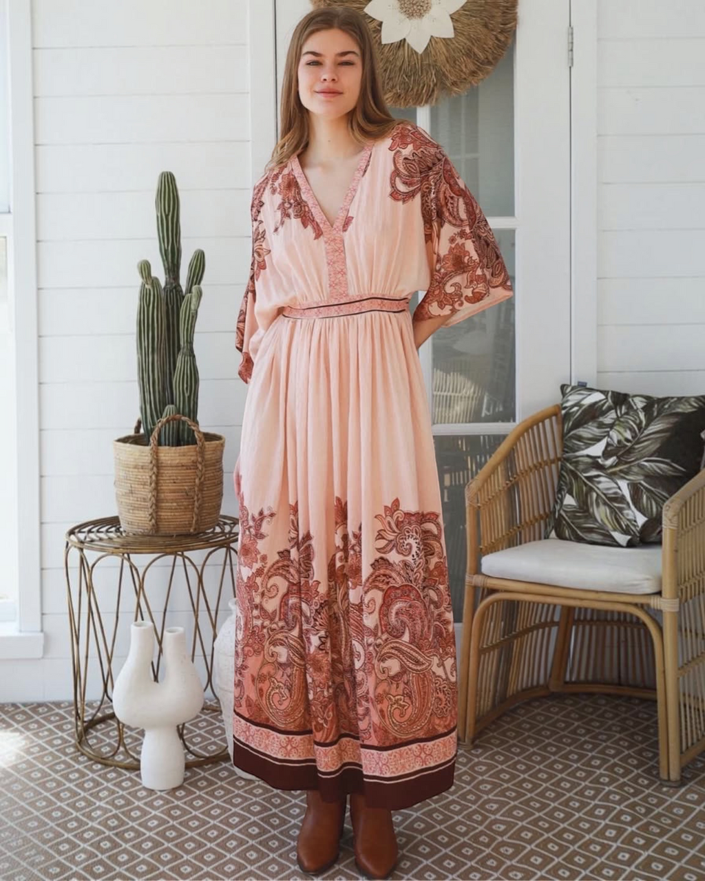 Thrift N Gift bohemian maxi dress in blush with terracotta paisley print, V-neck, and kimono sleeves on a model.