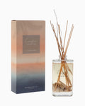 Thrift N Gift Bramble Bay Coastal Sunrise reed diffuser in a glass bottle with sand, seashells, and willow sticks.