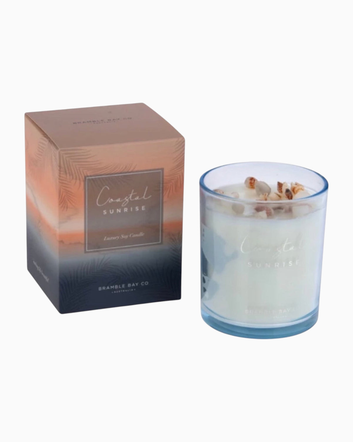 Thrift N Gift Bramble Bay Coastal Sunrise soy candle in an ocean blue glass jar topped with authentic sea shells.