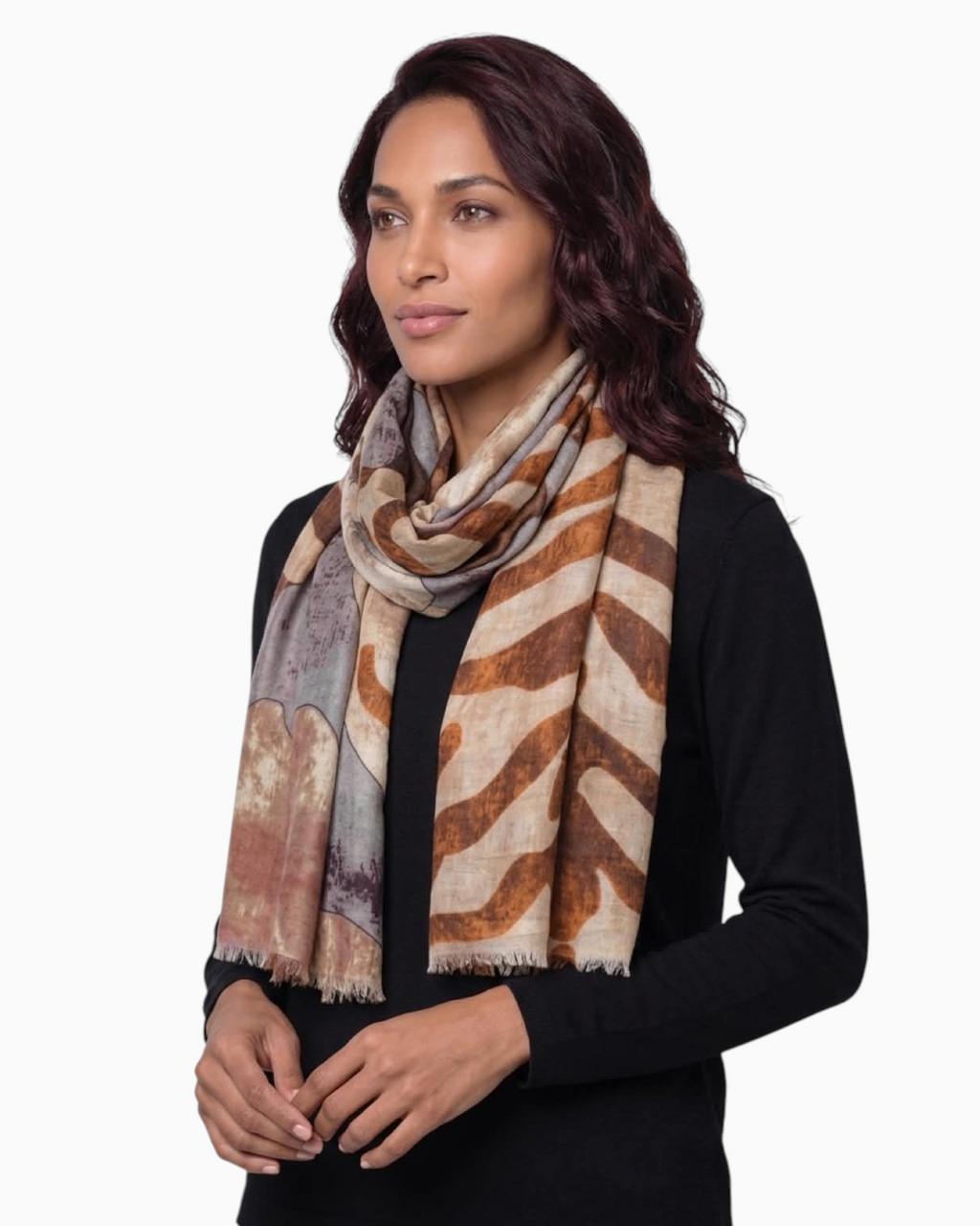 Model wearing a Thrift N Gift lightweight abstract print scarf in earth tones with frayed edges over a black top.