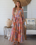 Thrift N Gift floral print button down maxi dress with tiered skirt, long sleeves, and waist tie in warm pastel hues.