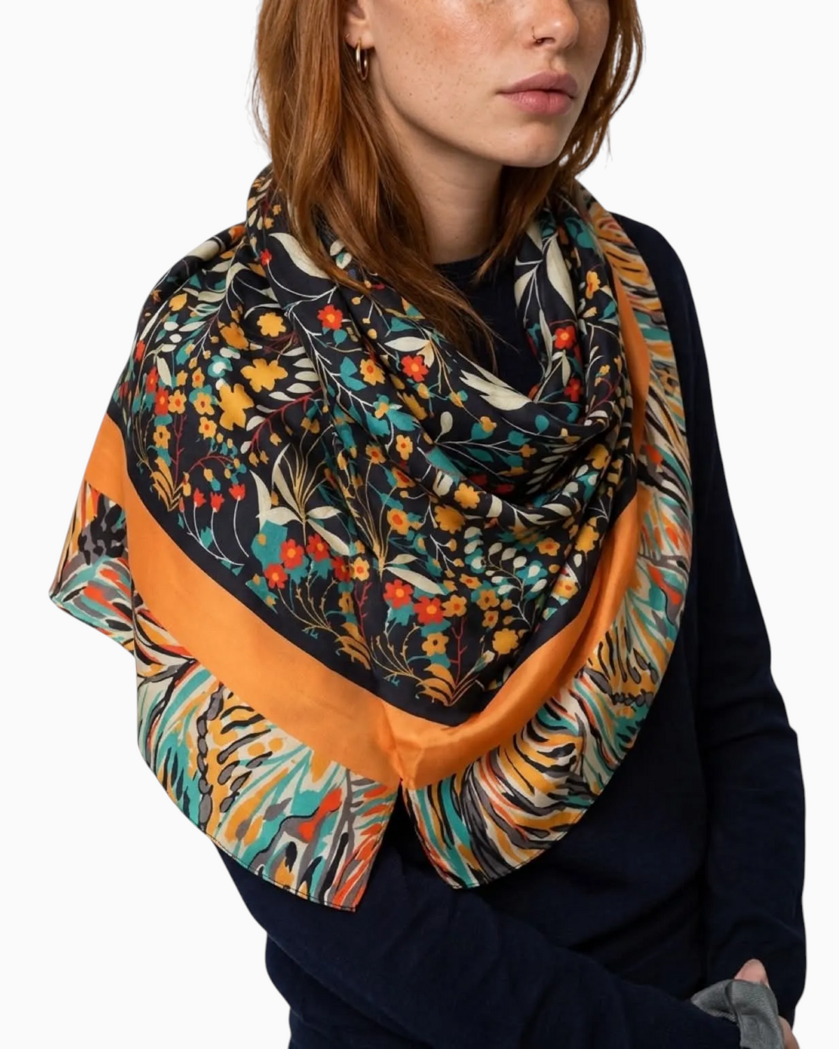 Thrift N Gift lightweight scarf with dark floral print, orange border, and teal and gold botanical accents on model