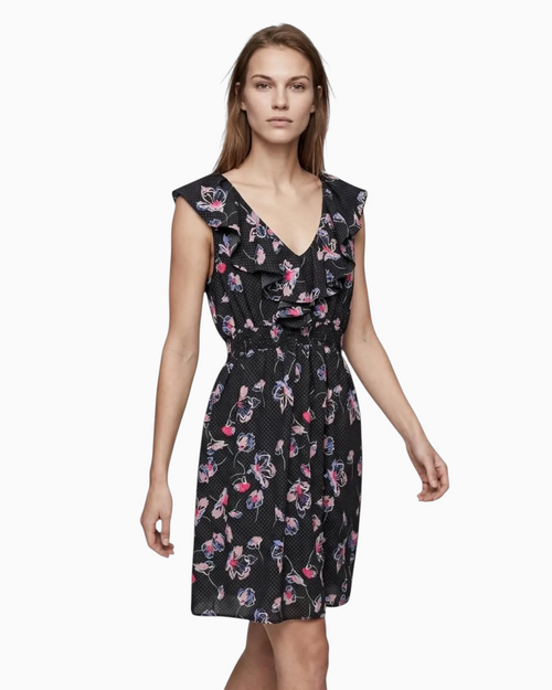 Thrift N Gift floral print mini dress with ruffled V-neck, polka dot pattern, and elastic waist on a model