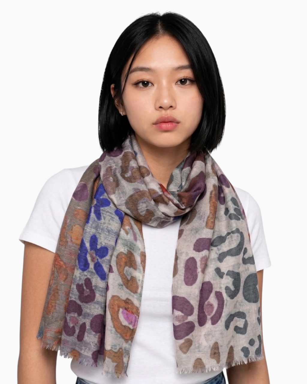 Thrift N Gift lightweight multi-colored leopard print scarf with frayed edges worn by a woman in a white t-shirt