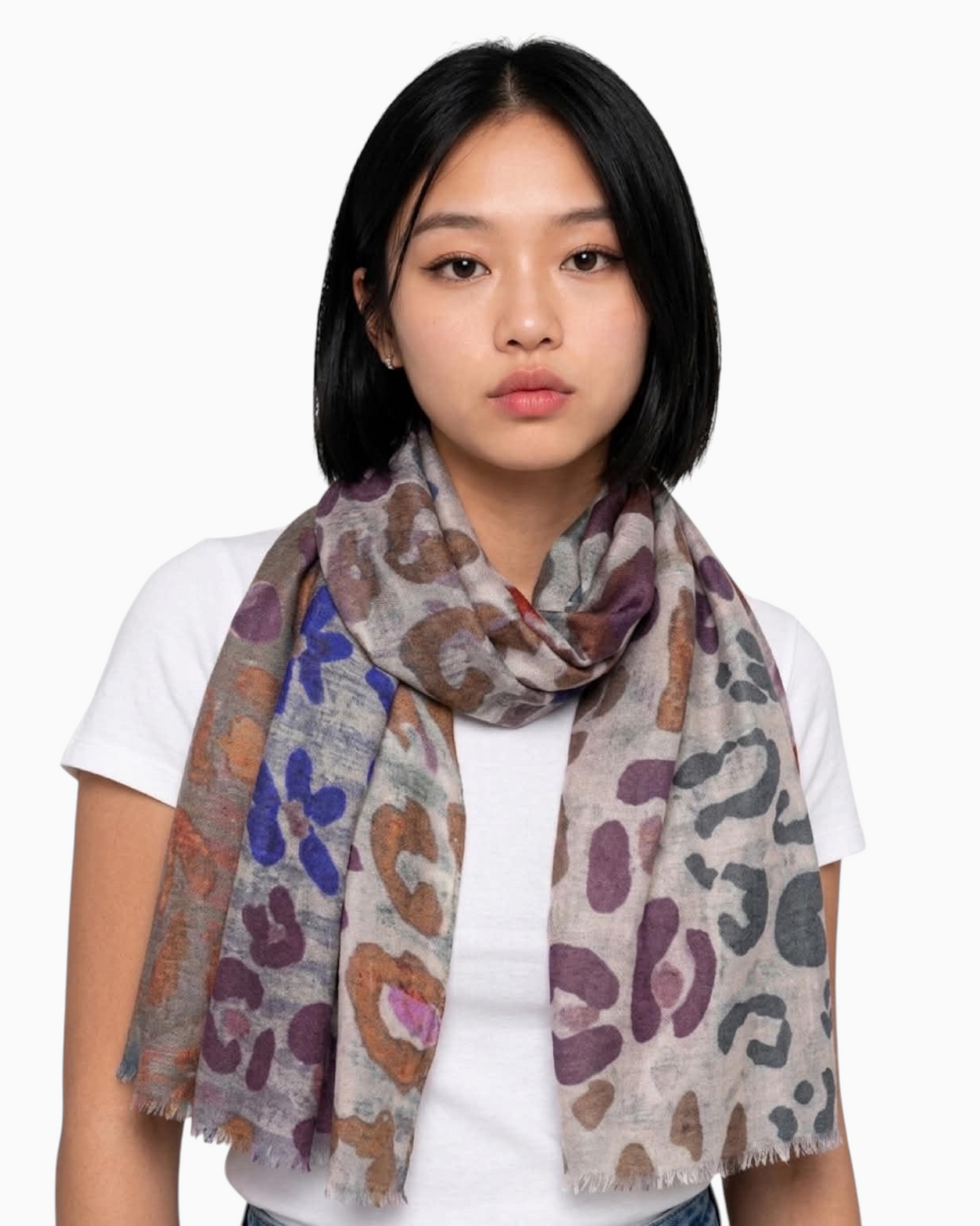 Thrift N Gift lightweight multi-colored leopard print scarf with frayed edges worn by a woman in a white t-shirt