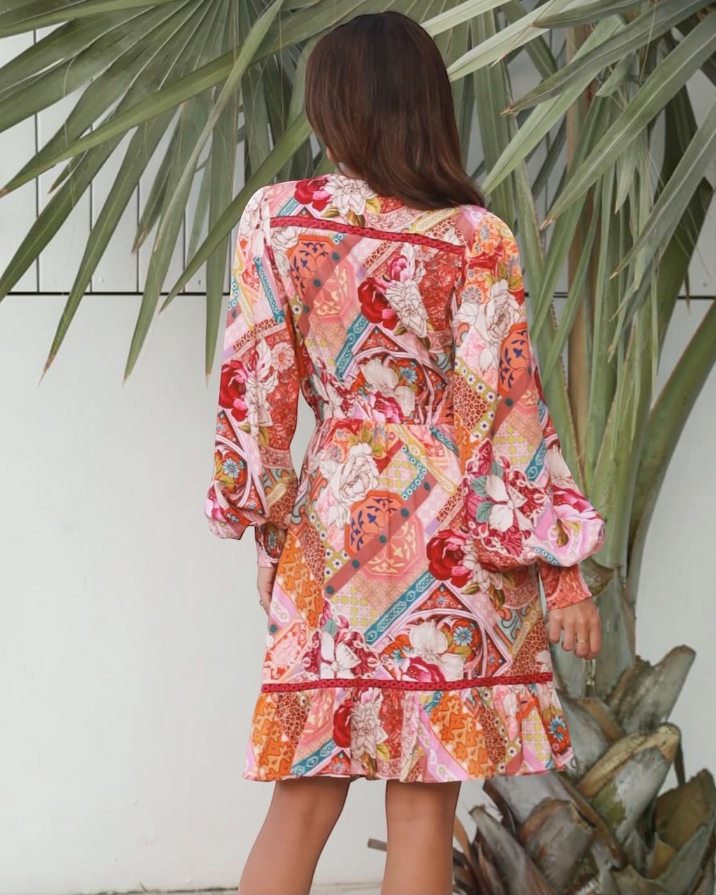 Thrift N Gift long sleeve mini dress featuring a vibrant patchwork floral and geometric print with a ruffled hem