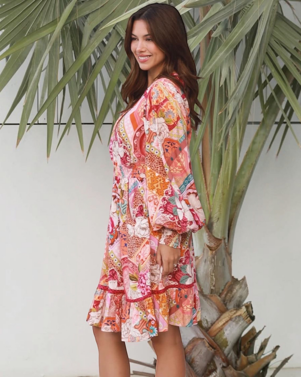 Thrift N Gift bohemian mini dress with long sleeves, featuring a vibrant patchwork floral print and ruffled hemline.