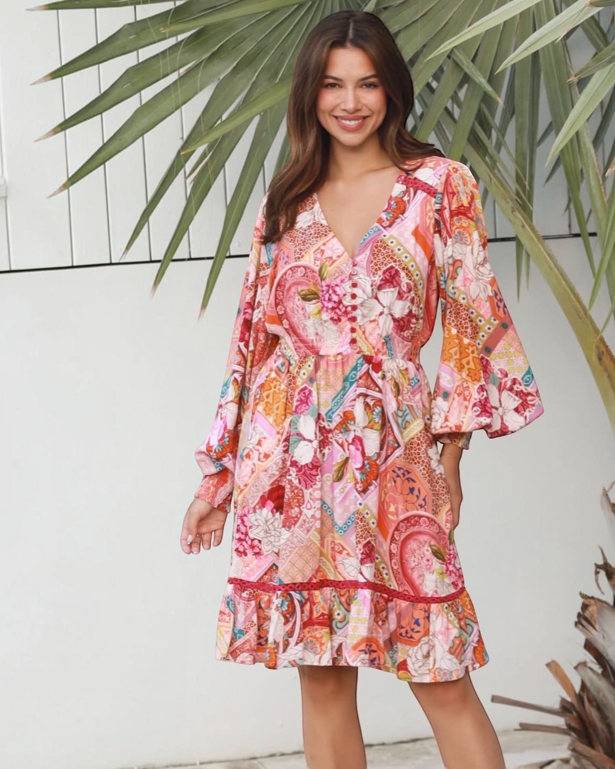 Thrift N Gift long sleeve mini dress with a vibrant floral and geometric patchwork print, V-neck, and ruffled hem.