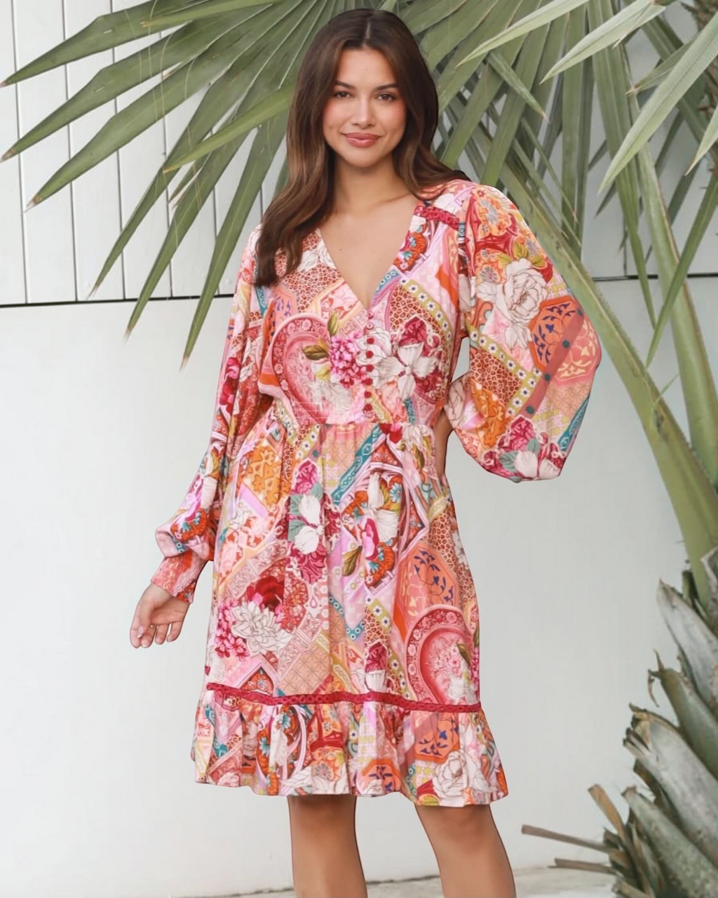 Thrift N Gift long sleeve mini dress with a vibrant floral and geometric patchwork print, V-neck, and ruffled hem.
