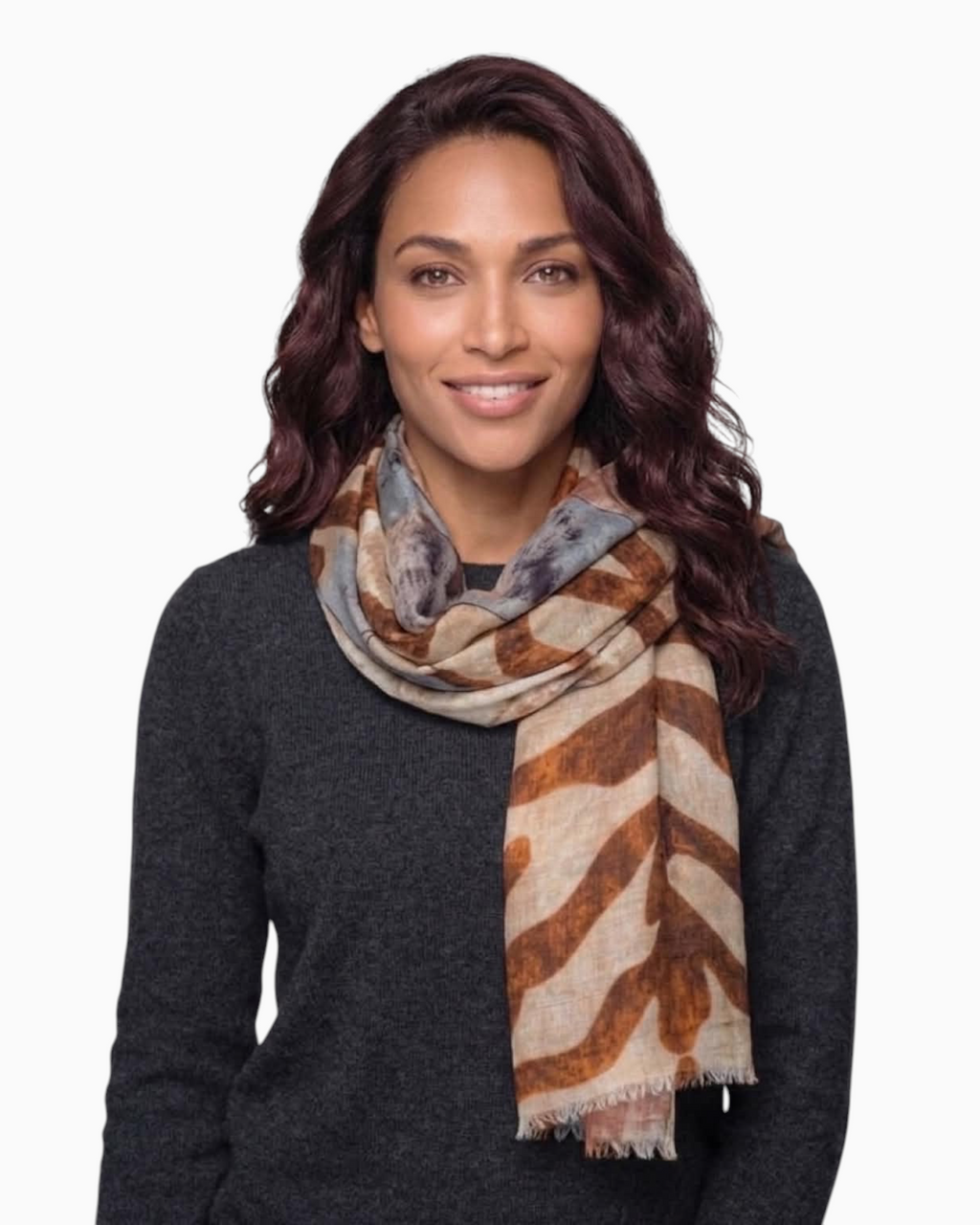 A model wearing a Thrift N Gift lightweight scarf with an abstract brown, tan, and grey print and frayed edges.