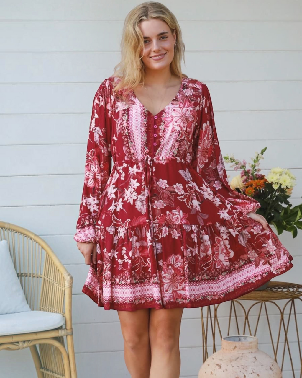 Thrift N Gift red floral print mini dress with long billowy sleeves, V-neck, and tiered skirt on a blonde model