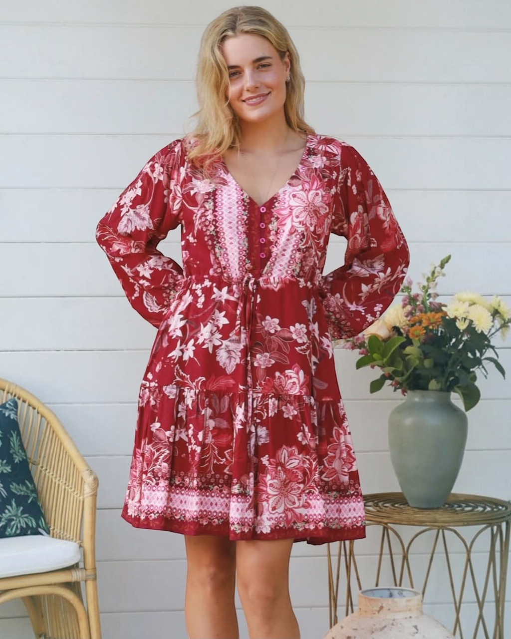 Thrift N Gift red floral print mini dress with long billowy sleeves, V-neckline, and tiered skirt on a blonde model