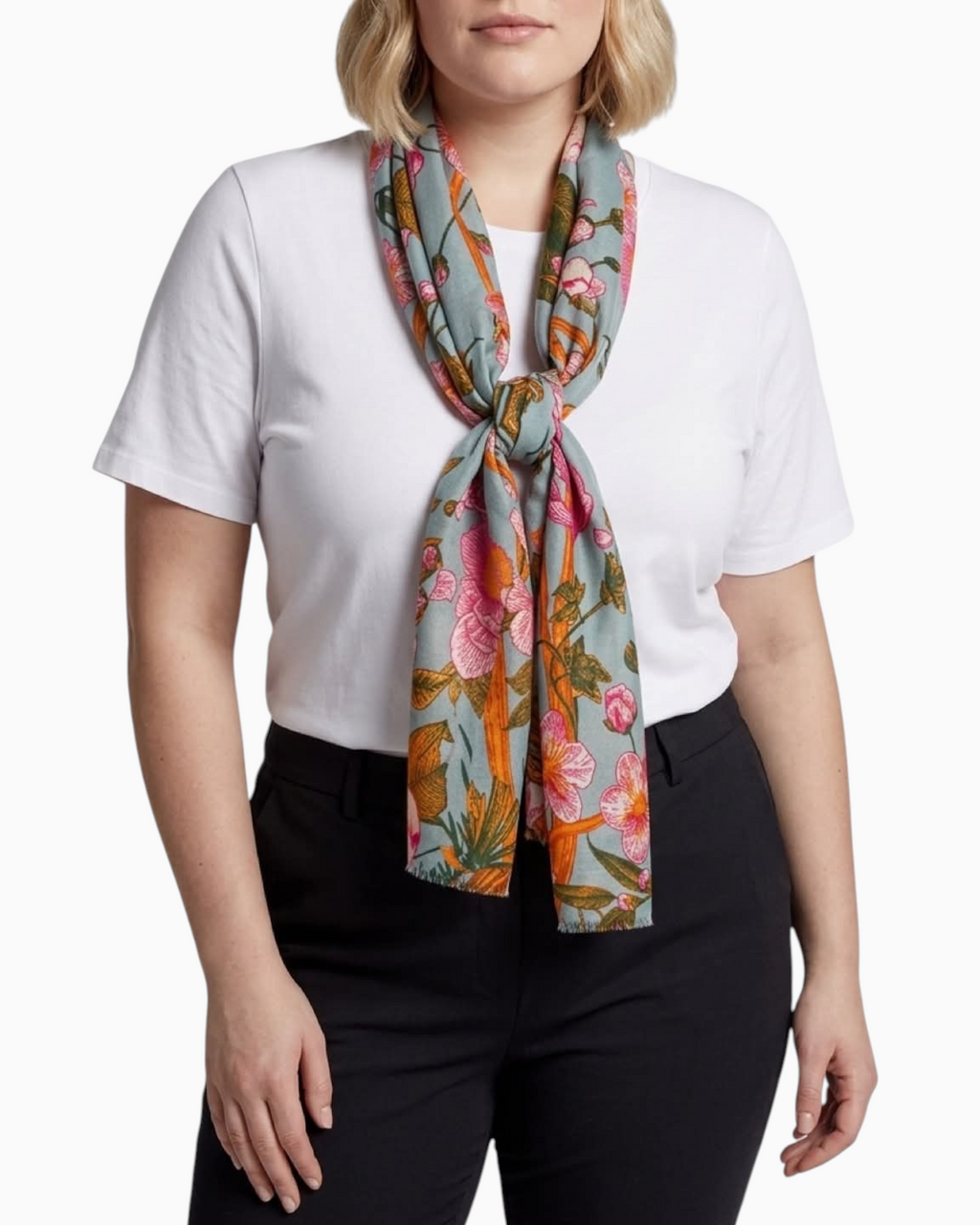 Thrift N Gift sage green lightweight scarf with pink floral and amber branch print worn by a woman in a white tee